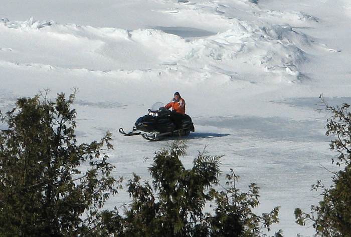 Snowmobile on ice in the Straits of Mackinac.
