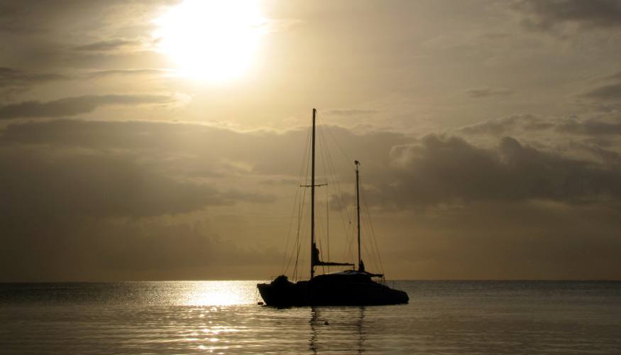 Sailboat and setting sun in Aruba