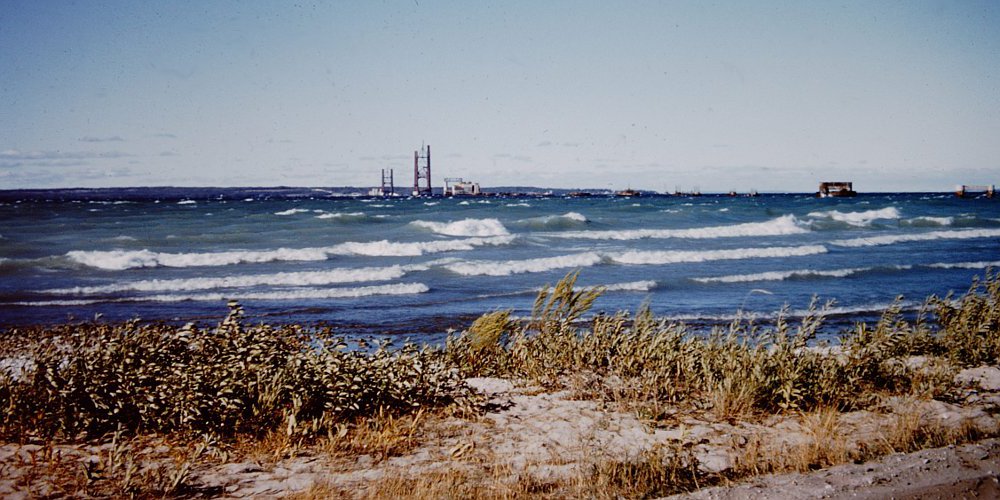 Early Mackinac Bridge construction and Great Lakes freighter